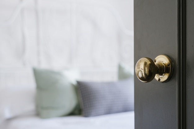 Closeup shot of a gold door knob on a black door