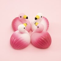 Closeup shot of a group of identical rubber flamingos facing each other