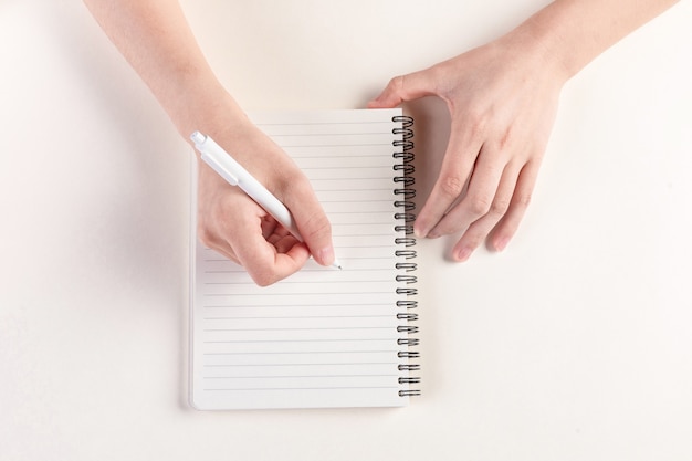 Closeup shot of a hand filling in a diary