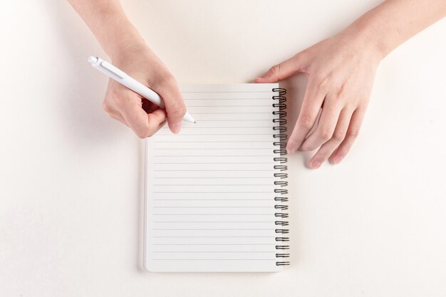 Closeup shot of a hand filling in a diary