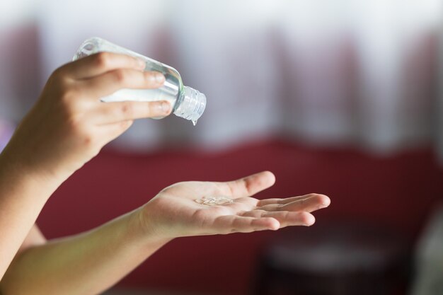 Closeup shot of hands using hand sanitizer