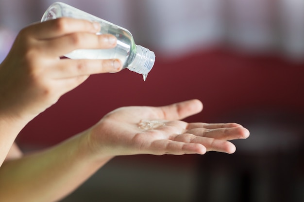 Closeup shot of hands using hand sanitizer