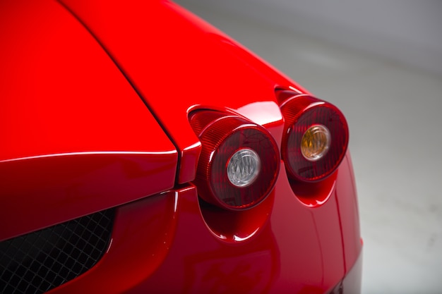 Closeup shot of the headlights of a modern red car