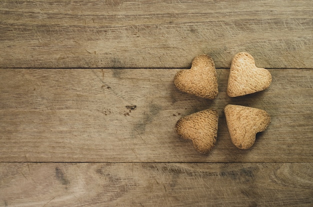 Closeup shot of hearth shaped cookies on wooden background