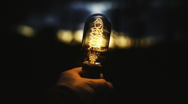 Closeup shot of a human hand holding a lamp