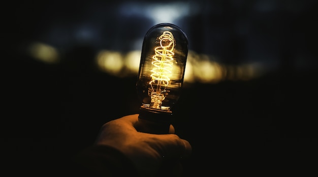 Closeup shot of a human hand holding a lamp