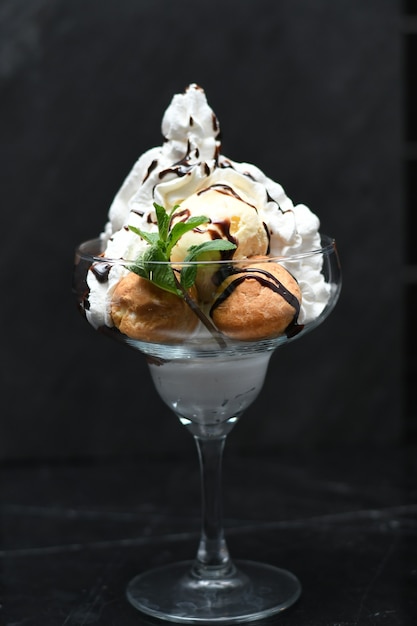 Closeup shot of Ice cream dessert with fruits and whipped cream