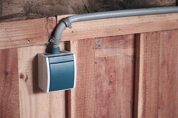 Closeup shot of a light switch on a wooden wall