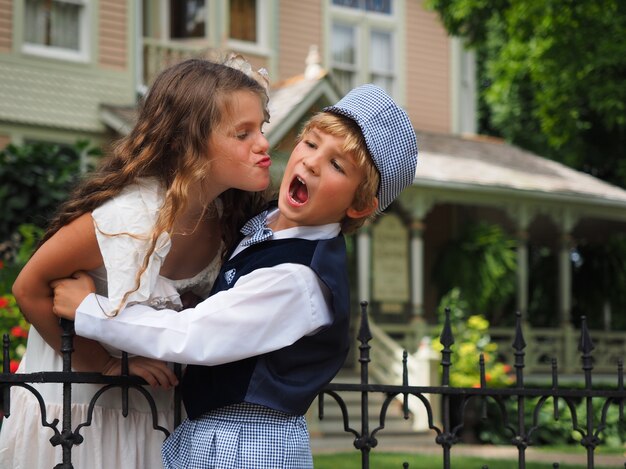 Closeup shot of a little girl trying to kiss a yelling boy