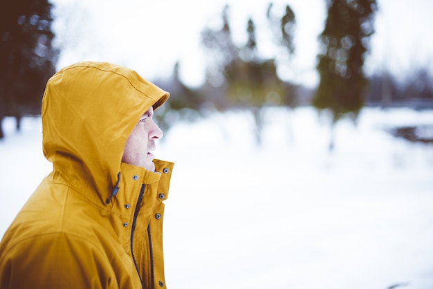 Free photo closeup shot of a male wearing a yellow winter jacket