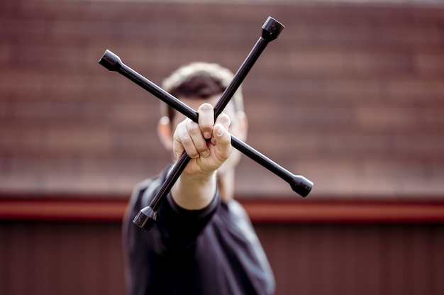 Free photo closeup shot of a man holding a metallic tool for installing a wheel