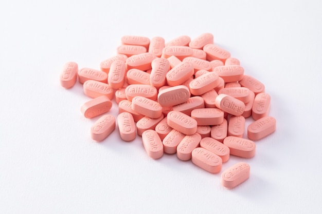 Closeup shot of many calcium tablets isolated on a white background