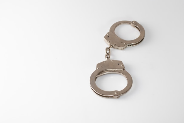 Closeup shot of a metal handcuffs on white