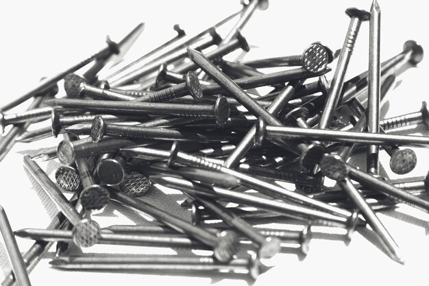 Closeup shot of metal nails on a white surface