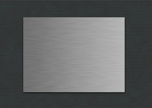 Closeup shot of a metal sheet on a grey leather background
