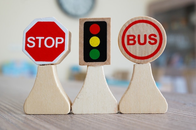 Closeup shot of miniature wooden road signs on a table