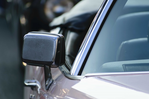 Closeup shot of the mirror of a metallic car