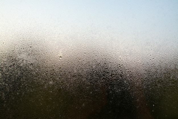 Снимок крупным планом туманного окна с каплями воды