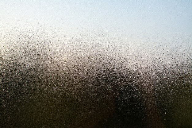 A closeup shot of a misty window with water droplets