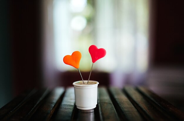 Closeup shot of a muffin with colorful hearts on it