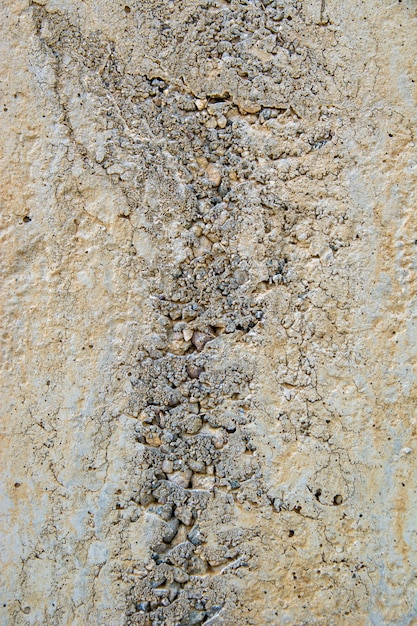 Closeup shot of naturally weathered grungy wall with oil paint leftovers on marble