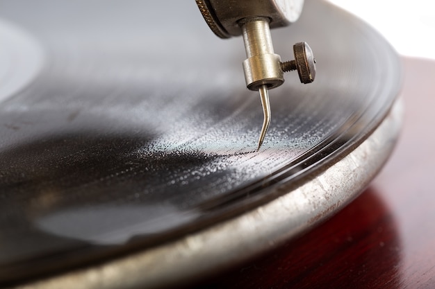 Closeup shot of a needle of the gramophone with a shellac disk