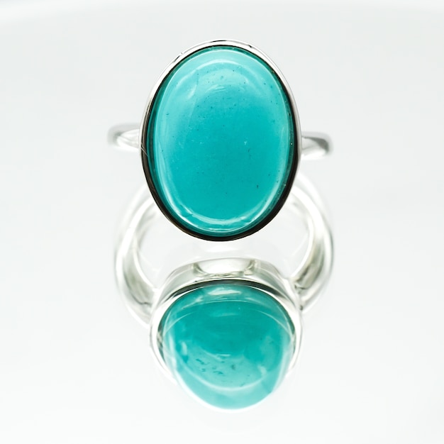 Closeup shot of an oval-shaped amazonite ring on a white surface