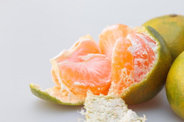 Closeup shot of a peeled tangerine on a gray background