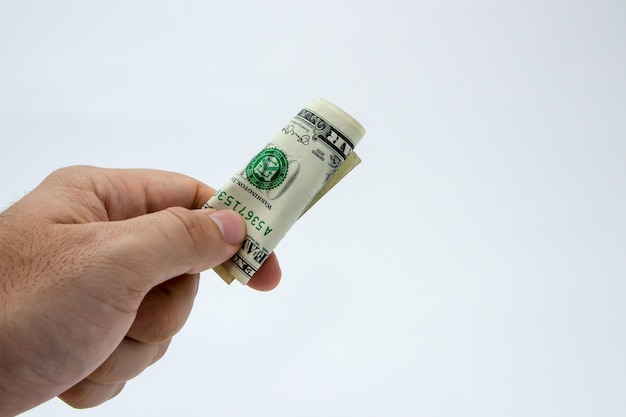 Free photo closeup shot of a person holding a dollar bill over a white background