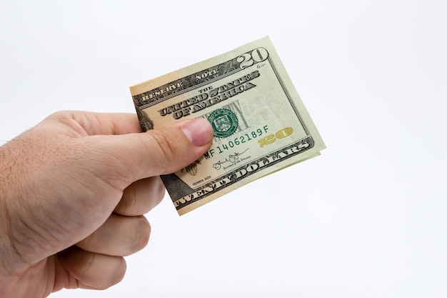 Closeup shot of a person holding a dollar bill over a white