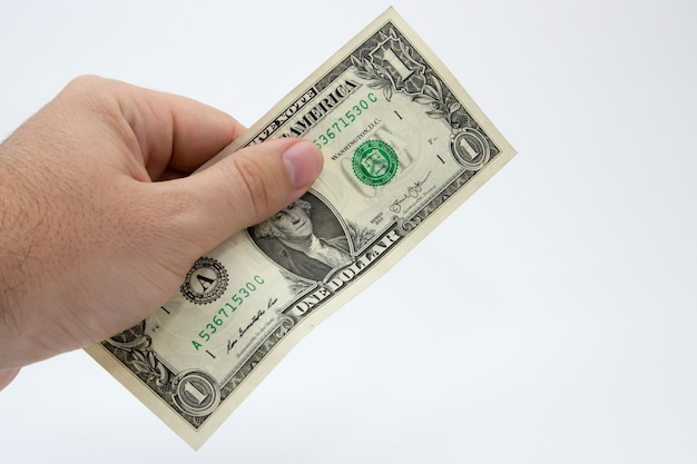 Снимок крупным планом человека, держащего долларовую купюру