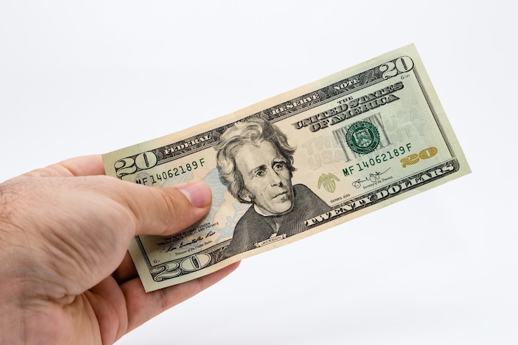 Free Photo closeup shot of a person holding a dollar bill