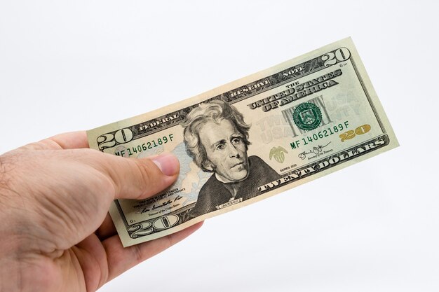 Closeup shot of a person holding a dollar bill