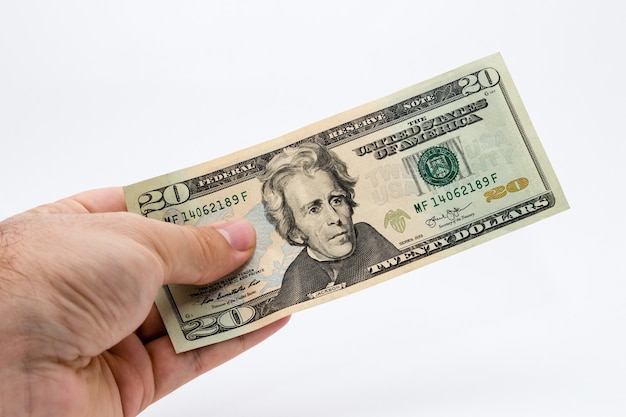 Closeup shot of a person holding a dollar bill