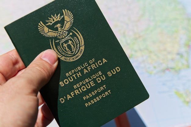 Closeup shot of a person holding the passport of the Republic of South Africa