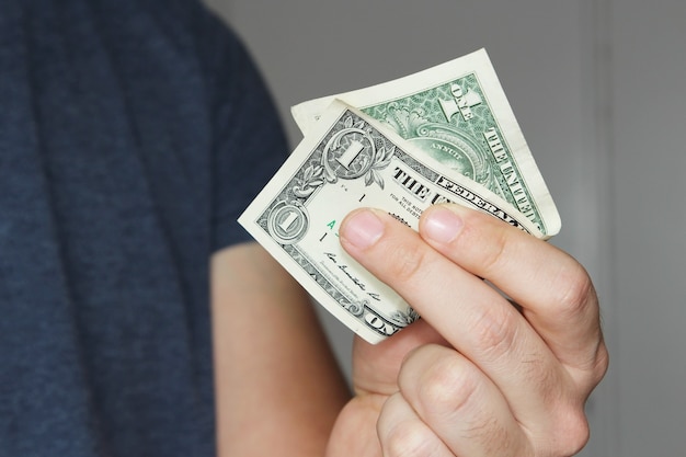 Closeup shot of a person holding a US dollar bill on his hand