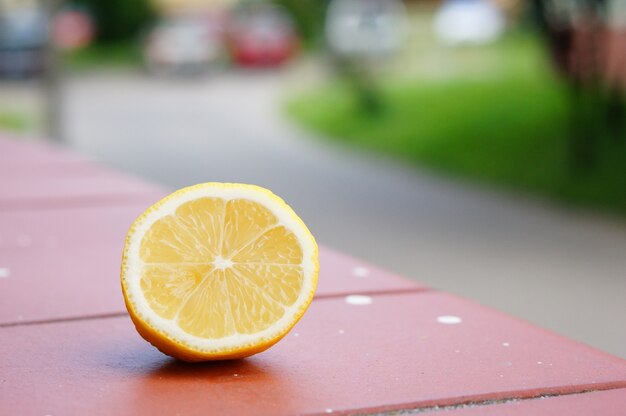 Closeup shot of a piece of cut lemon on a wooden surface