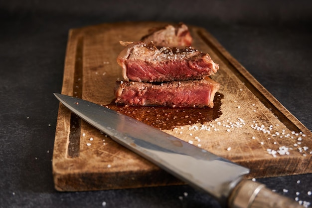 Closeup shot of rare steak on a wooden board