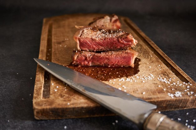 Closeup shot of rare steak on a wooden board