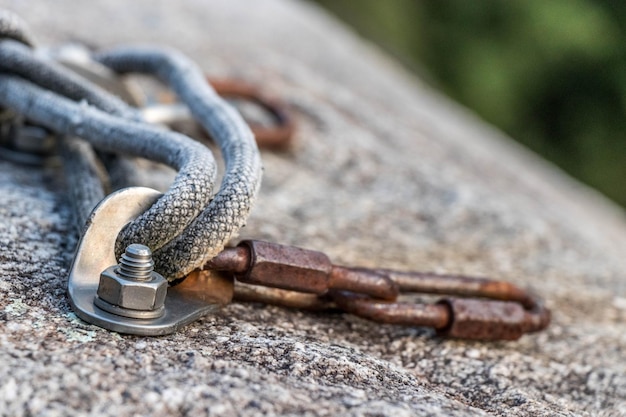 Closeup shot of a rope attached to the rock for rock climbing in Ticino Switzerland