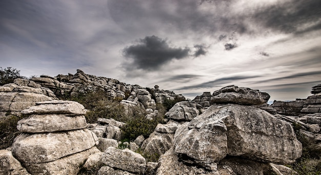 Closeup shot of several grey rocks on top of each other under a cloudy sky