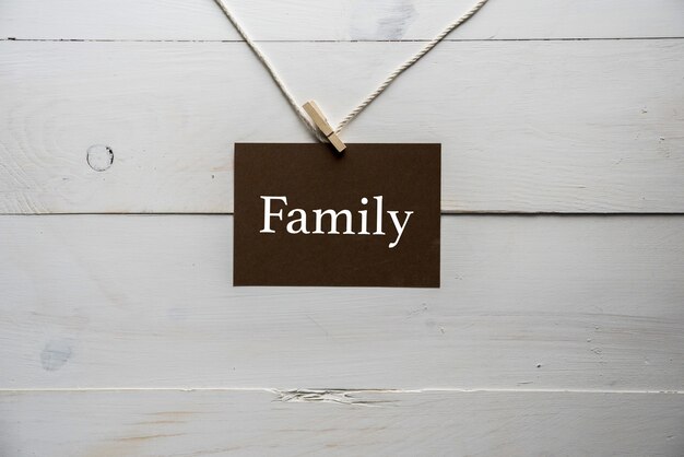 Closeup shot of a sing attached to a string with family written on it