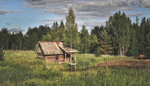 Closeup shot of a small house near a pond in the countryside