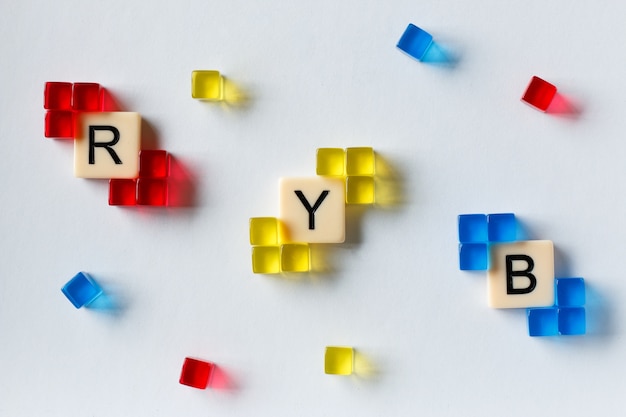 Крупным планом - маленькие красные, синие и желтые квадратные кристаллы, демонстрирующие цветовую модель RYB.