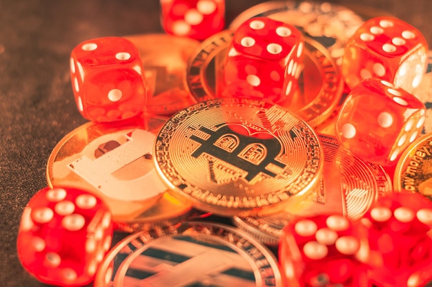 Free photo closeup shot of some bitcoins and red dice