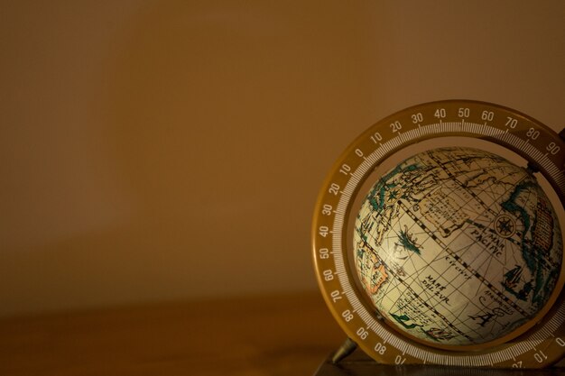 Closeup shot of a spinning globe on beige