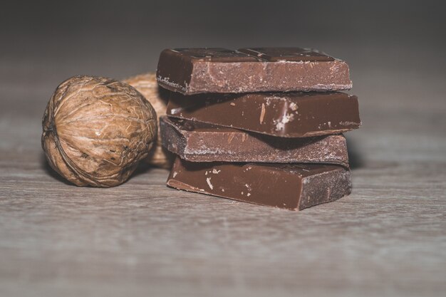 Closeup shot of a stack of chocolates with shelled walnuts