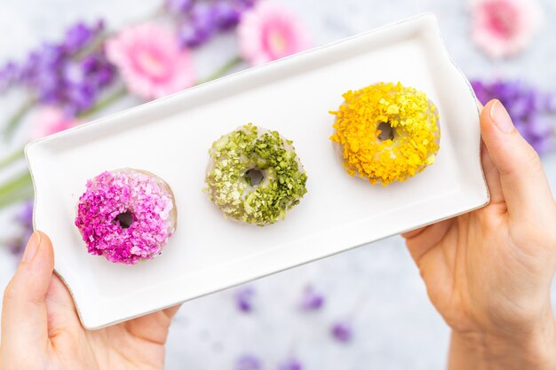 Closeup shot of tabletop of vegan raw colorful donuts