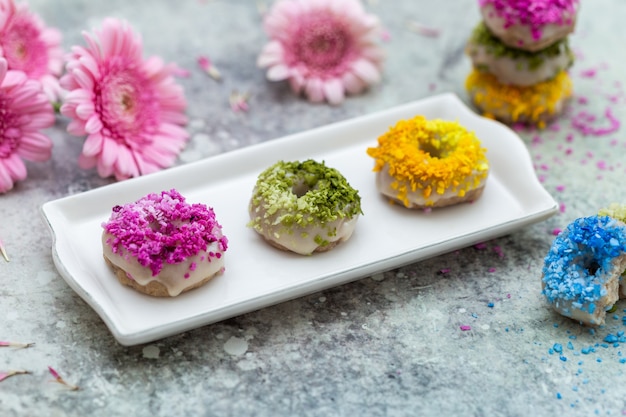 Closeup shot of tabletop of vegan raw colorful donuts