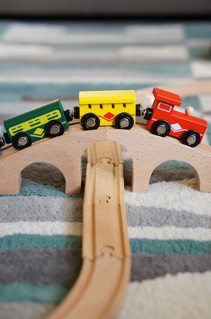 Closeup shot of a toy train on a wooden bridge